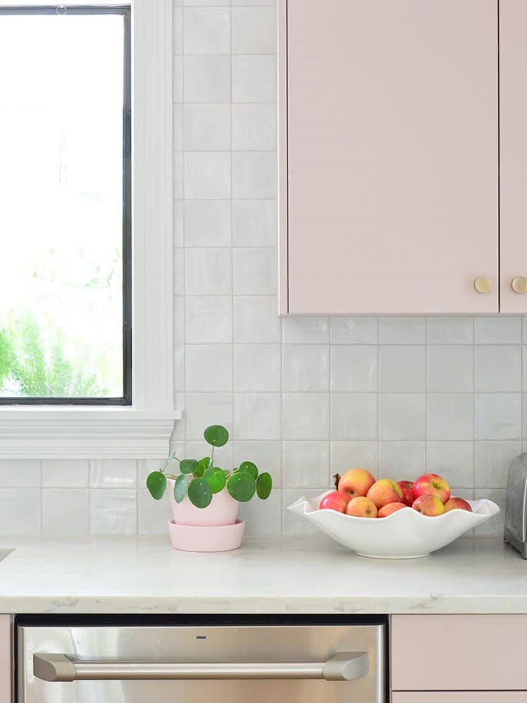 Small kitchen with square tile backsplash running all the way to the ceiling
